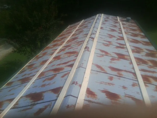Rusted metal roof panels with new wood purlins before replacement — Storm Damage Roof Repair in Boyds by Roofing Brothers